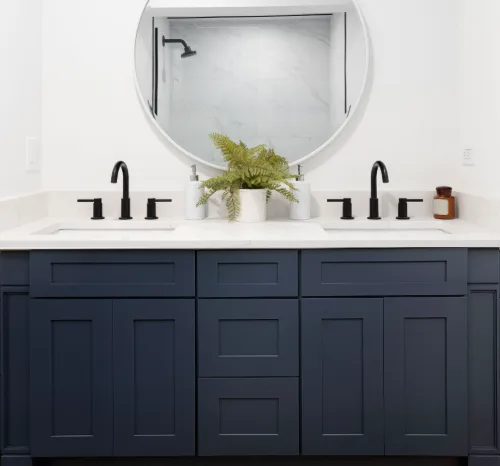 Bathroom with a navy CabTec Shaker double vanity