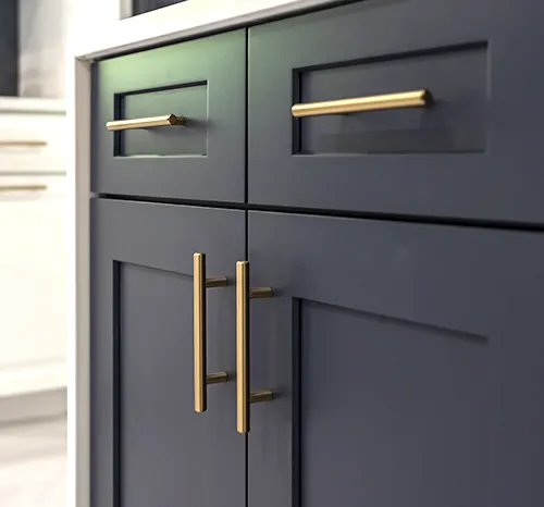 Premium brass hardware on custom navy blue shaker cabinets