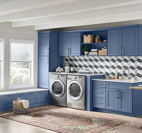 Laundry room with blue Wolf Classic cabinets and a built-in window seat